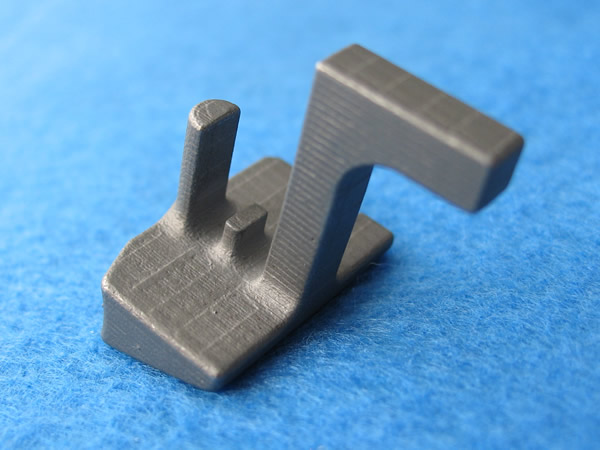 Investment casting of a nailer, construction hand tool part made from 4340 Steel Alloy.