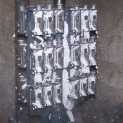 Once trees have cooled, the shell material is removed in vibrating cabinet.